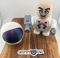 Toy figure in a white space suit with space helmet on wooden platform. 