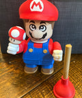 Super Mario figurine holding a mushroom on a wooden surface