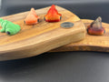 Three small fidget hammer head sharks  on a wooden surface with a coin for scale.