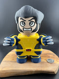 Toy figure of a character in a yellow and blue costume on a wooden stand with a dark background