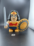 Toy figure of a character with a shield and sword on a dark surface