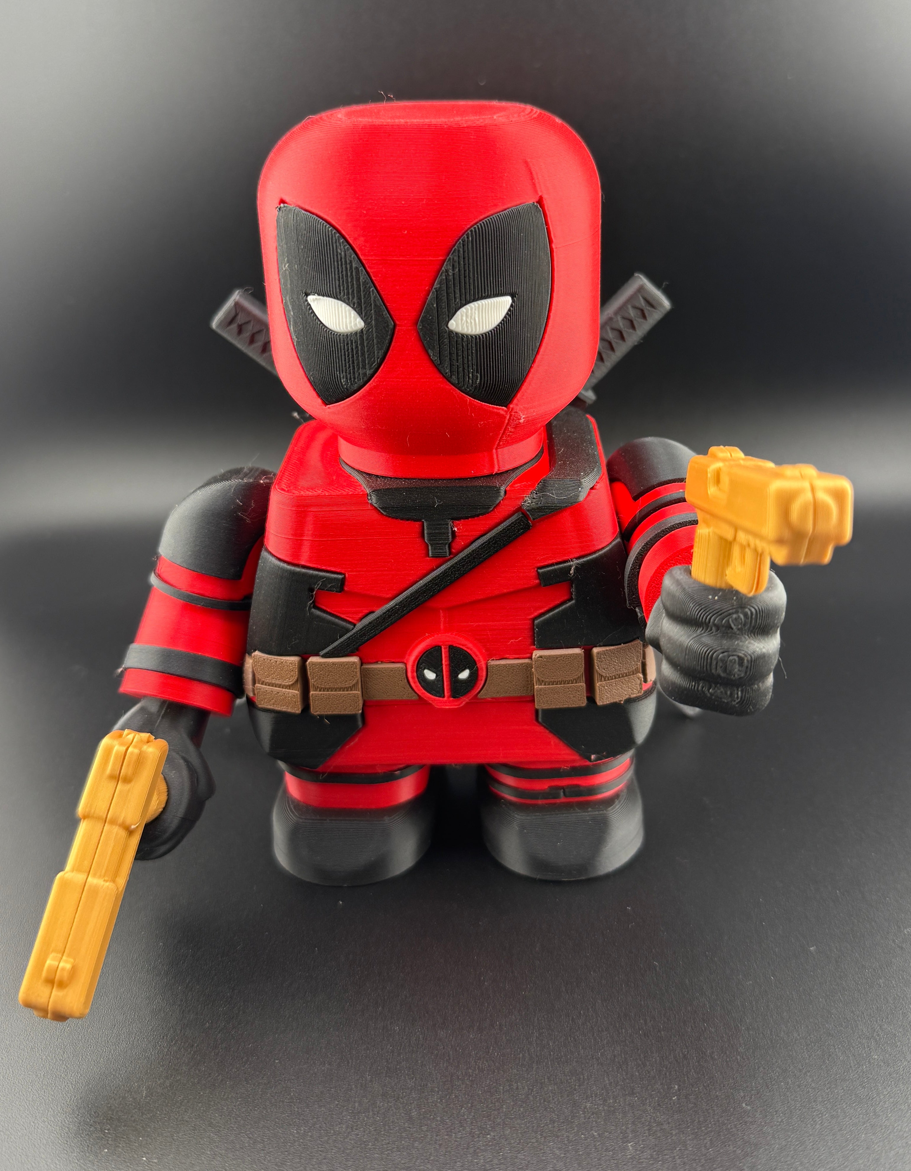 3D printed action figure holding yellow guns on a dark background
