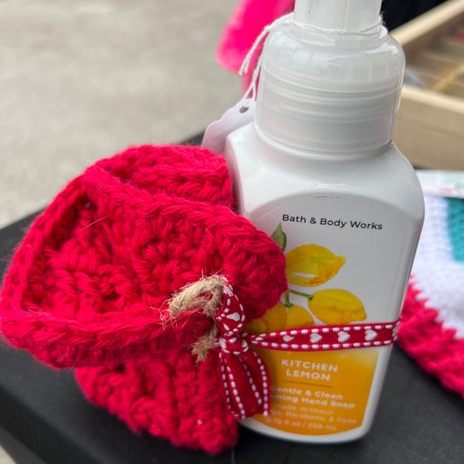 Bath & Body Works bottle of Kitchen Lemon soap with a red knitted item on a surface.